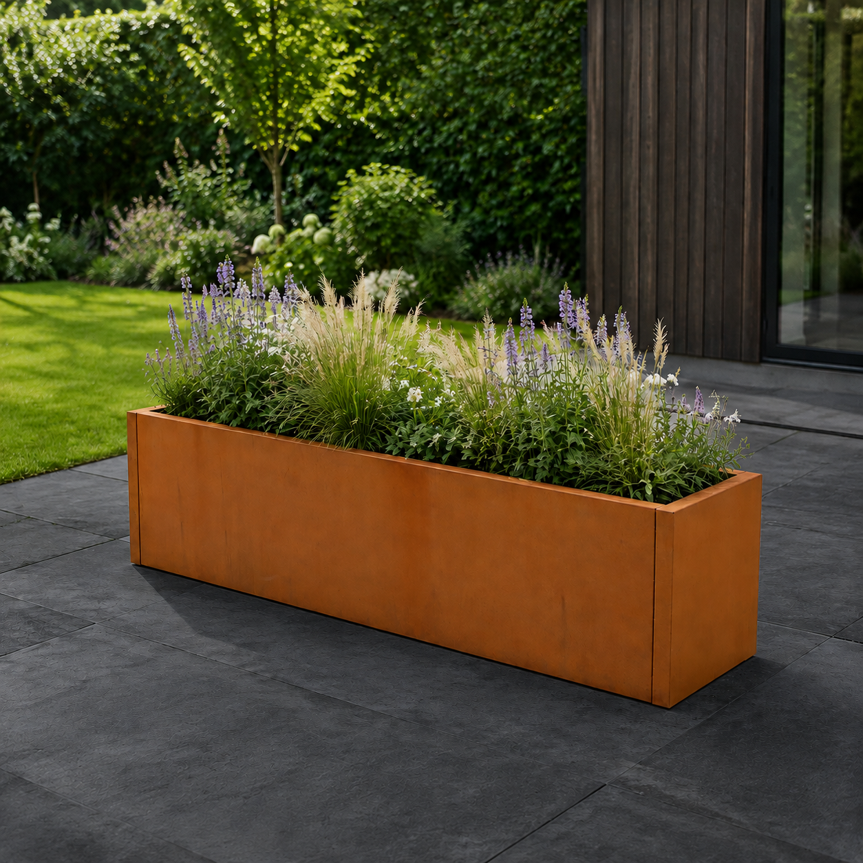 corten steel planter on dark grey patio in garden