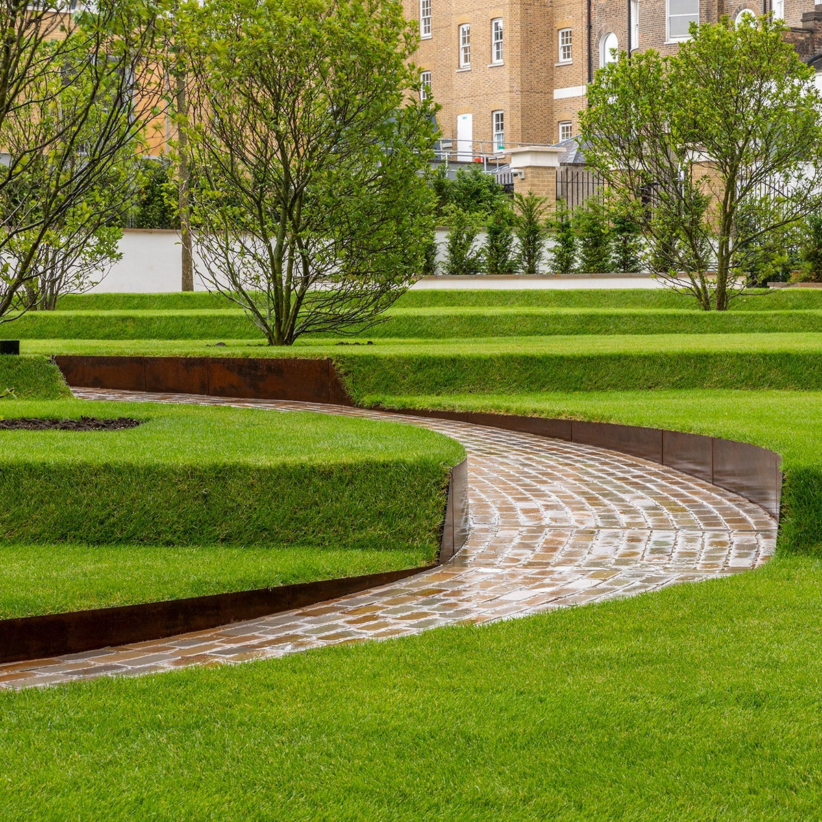 Contour Raised Bed System - Edge height 200mm [Bundle] GardenEdgingOnline.com. High Corten Steel Garden Edging, creating boundary between soil, lawn and gravel path. Tapered curved design to create levels, Lawn edge, garden border, flower beds, driveway raised edging. Metal, weathering steel, or powder coated steel.  Garden walkway, path and paving. Planter edge and retaining wall. Patio edge and garden walls.