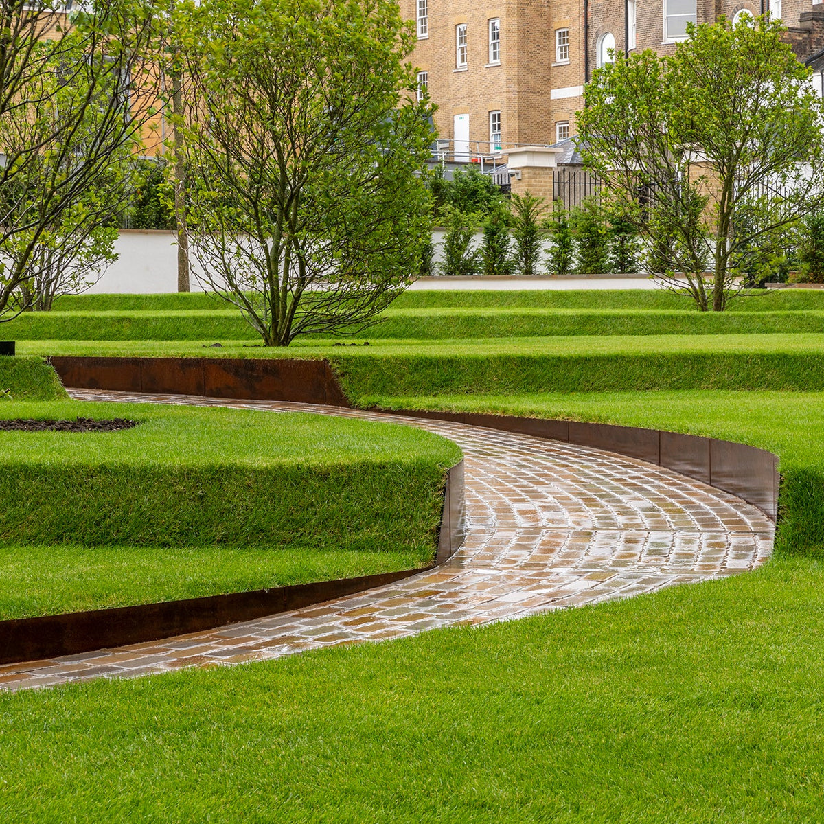 Contour corten planters - Edge height 200mm steel edging online Tapered curved lawn edge, creates levels within the area. High Corten Steel Garden Edging, creating boundary between soil, planting and gravel path. Lawn edge, garden border, flower beds, driveway raised edging. Metal, weathering steel, or powder coated steel.  Garden walkway, path and paving. Planter edge and retaining wall. Patio edge and garden walls.
